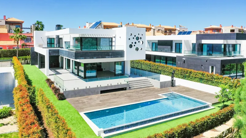 Modern villa with a swimming pool in the Algarve, with solar panels on the roof